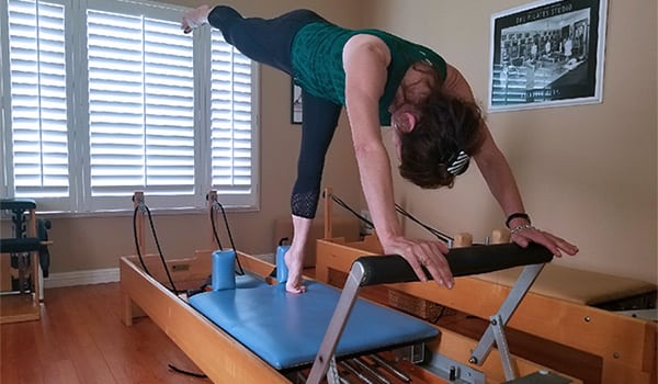 Devra Swiger doing Pilates on the reformer