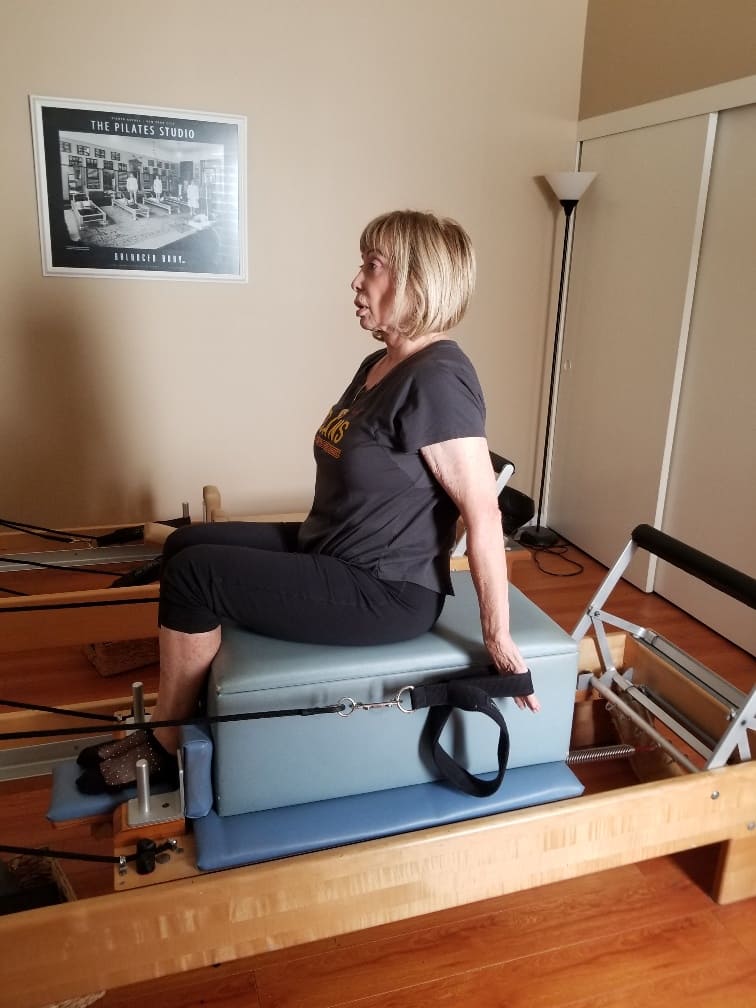 Woman doing Pilates exercises on the Reformer during a private Pilates session in HB