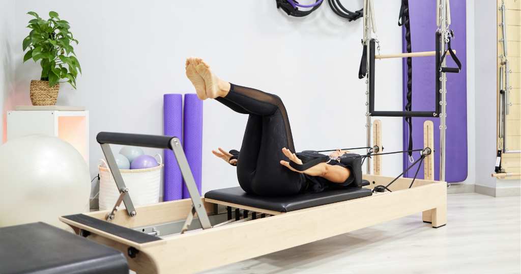 Woman diagnosed with osteoporosis performs safe Pilates exercises on the Reformer